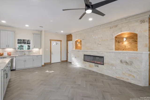 a kitchen with sink refrigerator and microwave