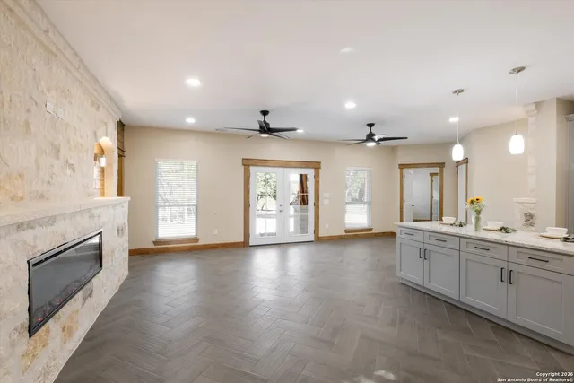 a kitchen with stainless steel appliances kitchen island granite countertop a refrigerator and a sink