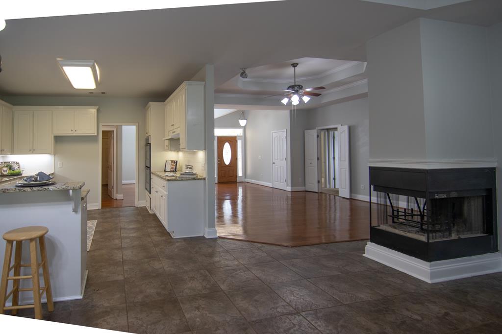 60 Roseanne Loop Hamilton, GA 31811 - Photo 11 of 54 a view of a kitchen with refrigerator and a fireplace