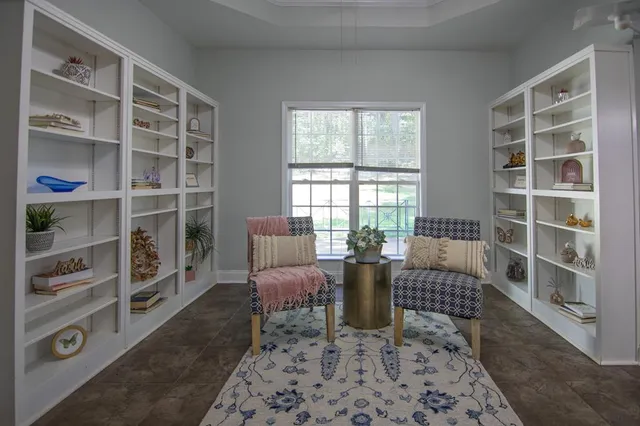 a view of a livingroom with furniture window and wooden floor