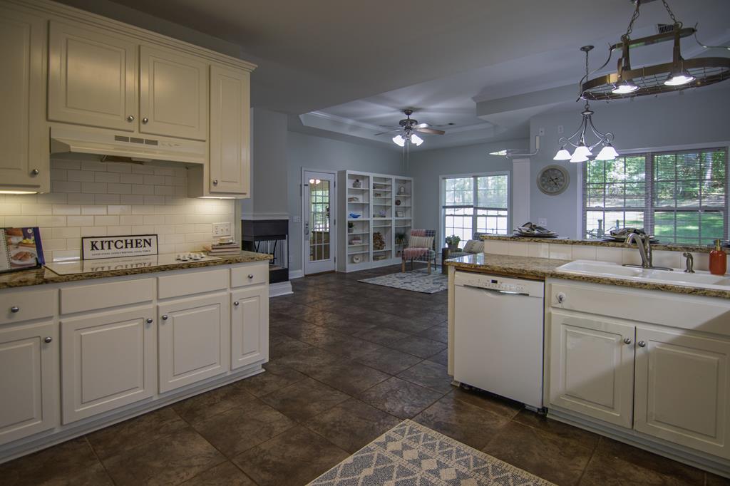 60 Roseanne Loop Hamilton, GA 31811 - Photo 18 of 54 a kitchen with cabinets a sink appliances and a counter top