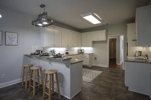 a kitchen with a sink cabinets and window