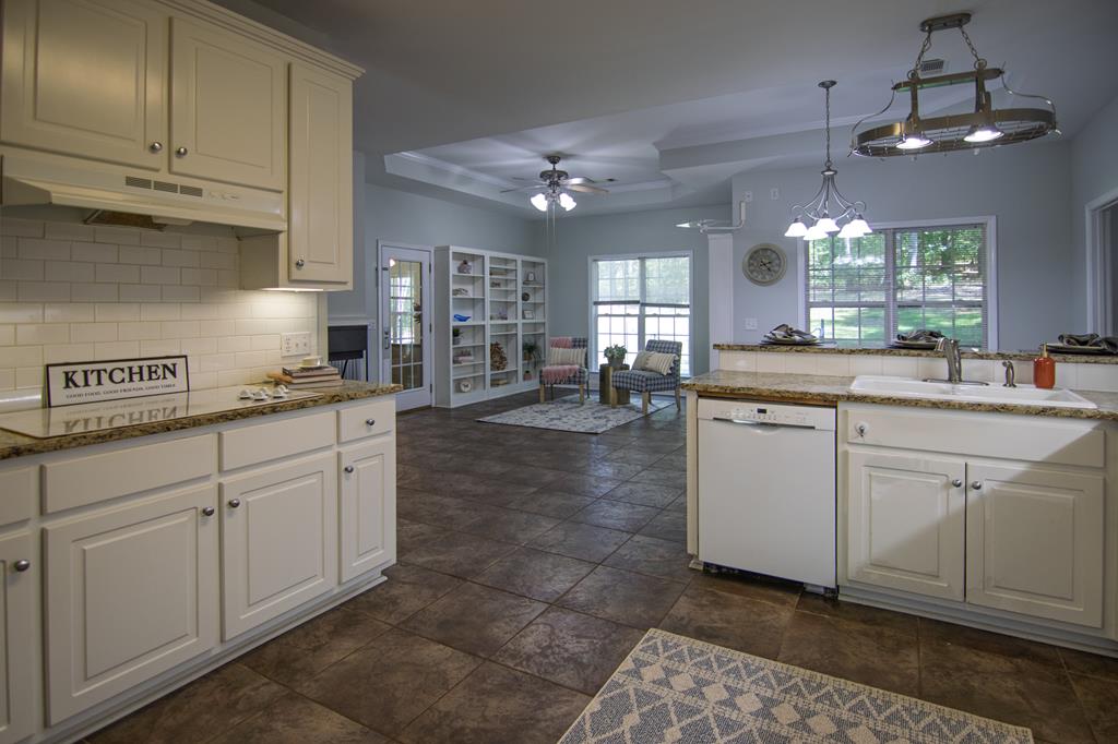 60 Roseanne Loop Hamilton, GA 31811 - Photo 20 of 54 a kitchen with kitchen island granite countertop a sink cabinets and stainless steel appliances