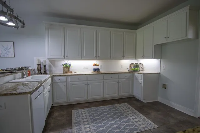 a kitchen with a sink cabinets and window