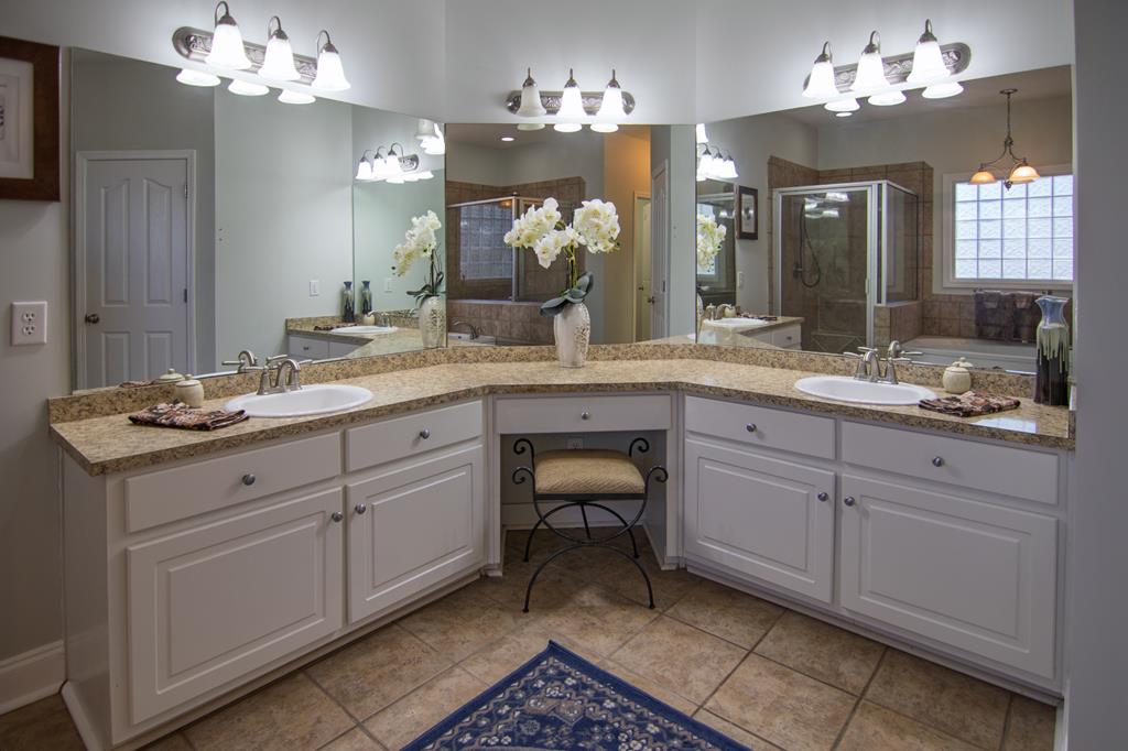 60 Roseanne Loop Hamilton, GA 31811 - Photo 27 of 54 a spacious bathroom with a granite countertop double vanity sink and a mirror