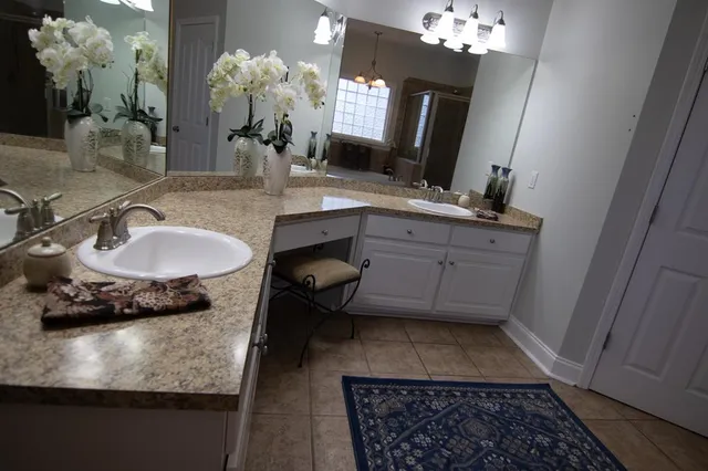 a spacious bathroom with a double vanity sink and a mirror