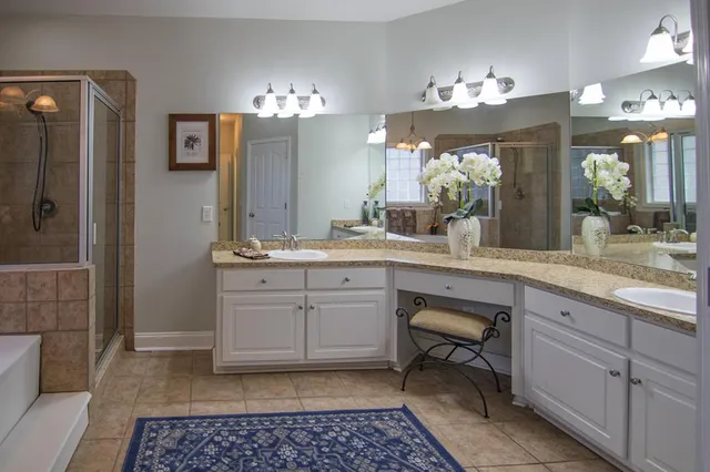 a bathroom with a tub shower and window
