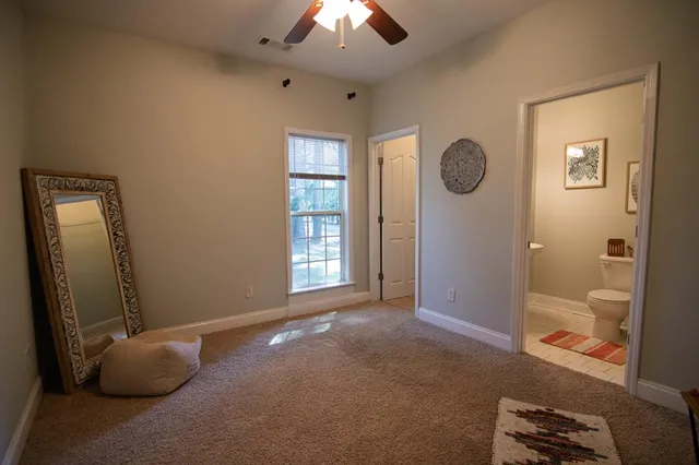 an empty room with windows and closet