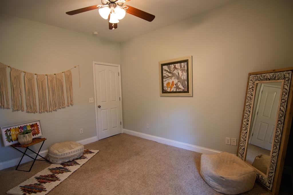 60 Roseanne Loop Hamilton, GA 31811 - Photo 34 of 54 a room with gym equipment and a mirror