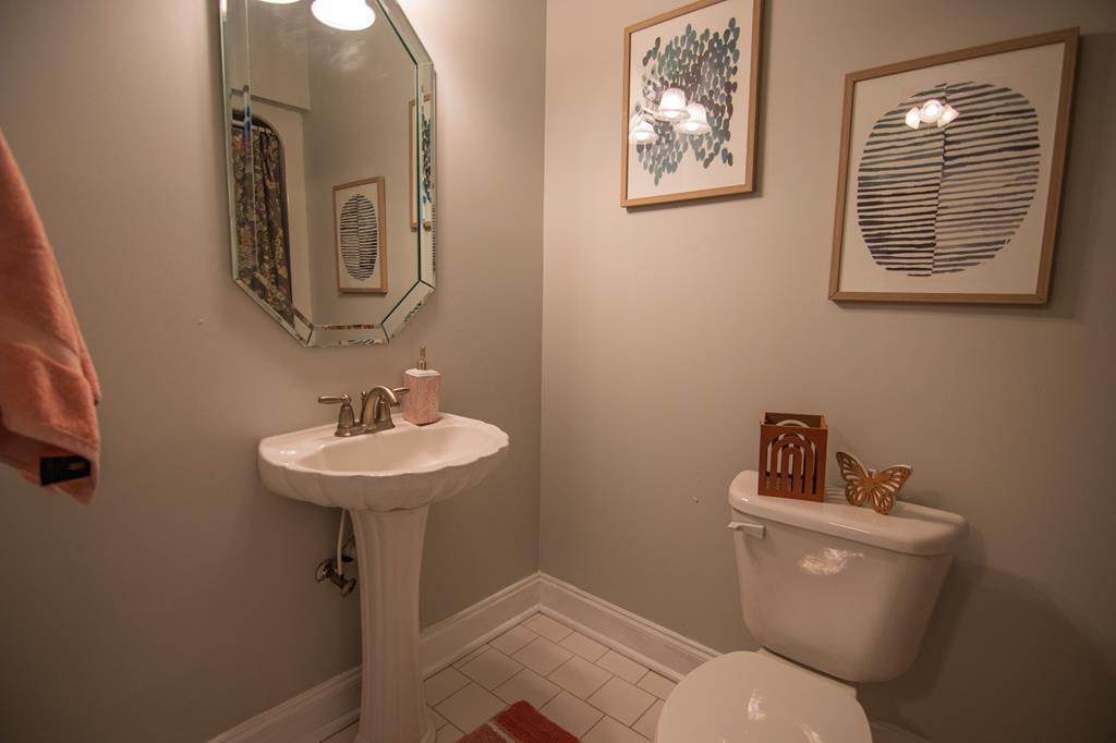60 Roseanne Loop Hamilton, GA 31811 - Photo 38 of 54 a bathroom with a toilet a sink and mirror