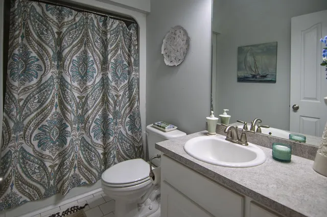 a living room with furniture and floor to ceiling windows