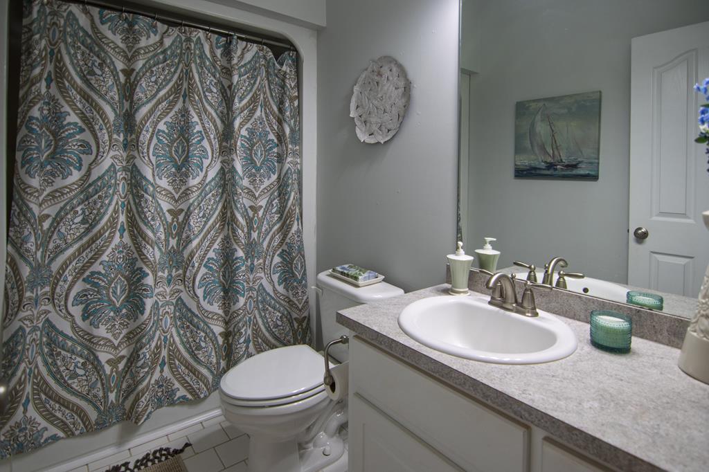 60 Roseanne Loop Hamilton, GA 31811 - Photo 42 of 54 a bathroom with a granite countertop sink and a toilet