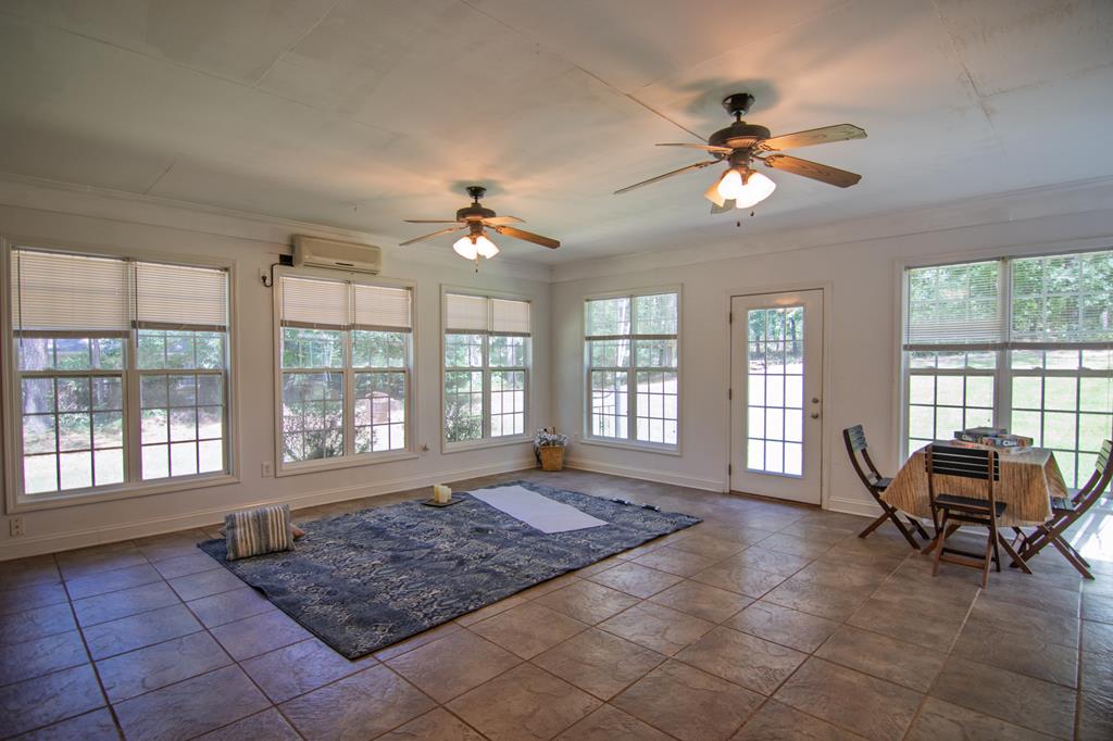 60 Roseanne Loop Hamilton, GA 31811 - Photo 45 of 54 a living room with furniture and floor to ceiling windows