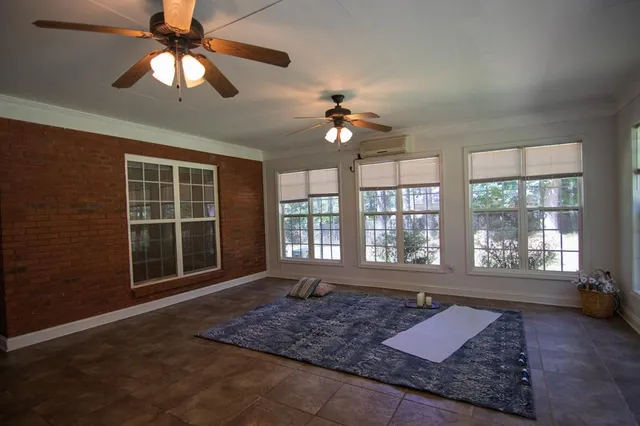 a backyard of a house with plants and large trees