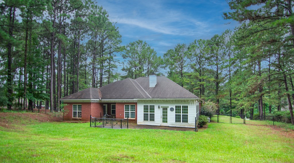 60 Roseanne Loop Hamilton, GA 31811 - Photo 50 of 54 a view of a house with a yard and sitting area