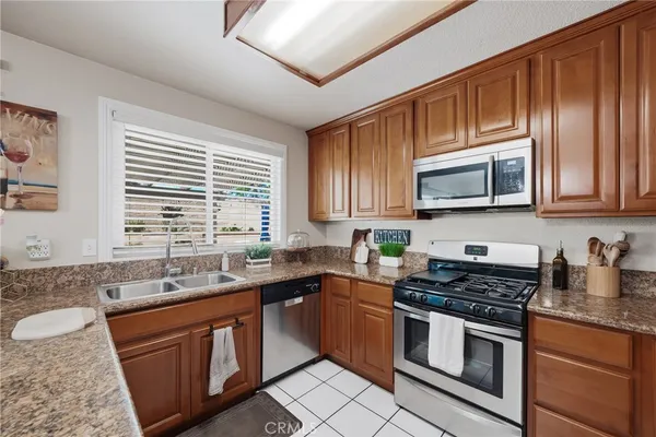 a kitchen with stainless steel appliances granite countertop a sink stove microwave and cabinets