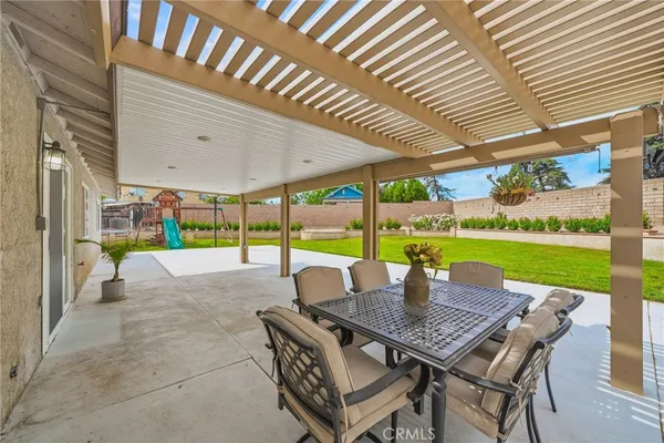 a view of a patio with a table and chairs