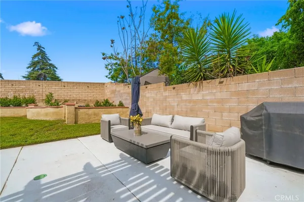 a view of a patio with couches and potted plants