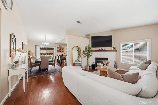 a living room with fireplace furniture and a flat screen tv