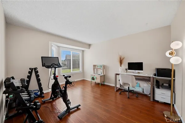 a view of a livingroom with workspace and a window