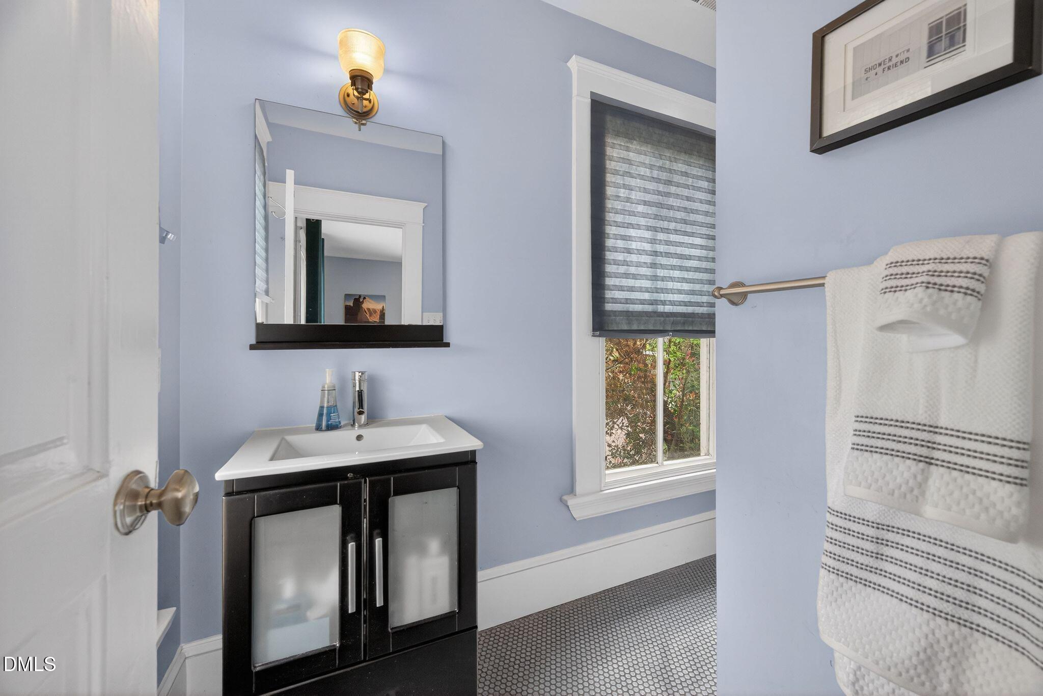 218 Pace Street Raleigh, NC 27604 - Photo 31 of 41 a bathroom with a sink a mirror and window