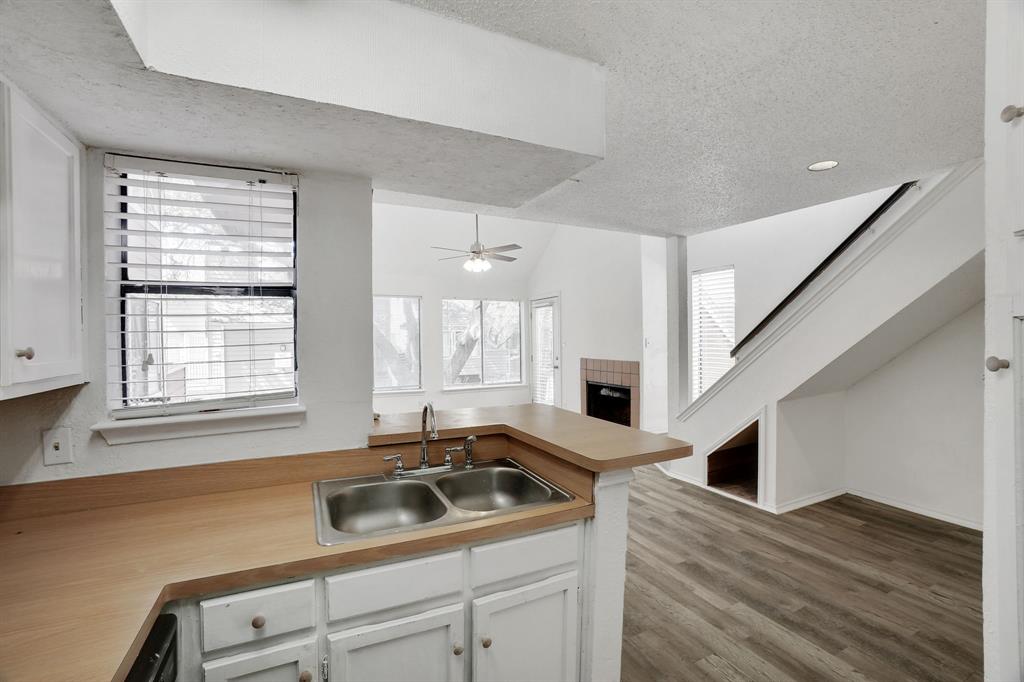 9821 Walnut Street, Unit 204 Dallas, TX 75243 - Photo 15 of 32 a kitchen with a sink stove and cabinets