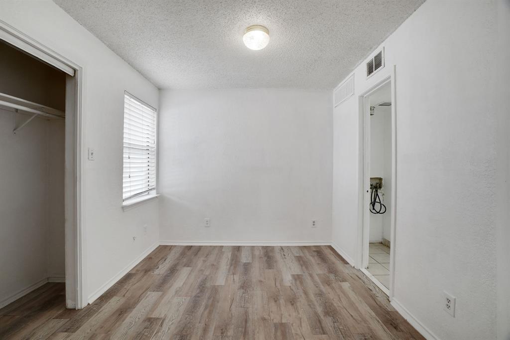 9821 Walnut Street, Unit 204 Dallas, TX 75243 - Photo 18 of 32 an empty room with wooden floor and windows