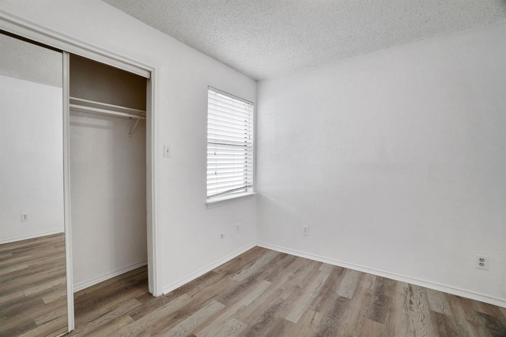 9821 Walnut Street, Unit 204 Dallas, TX 75243 - Photo 19 of 32 an empty room with wooden floor and windows