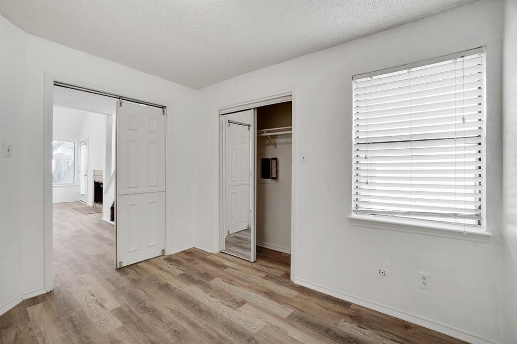 9821 Walnut Street, Unit 204 Dallas, TX 75243 - Photo 20 of 32 a view of an empty room with wooden floor and a window