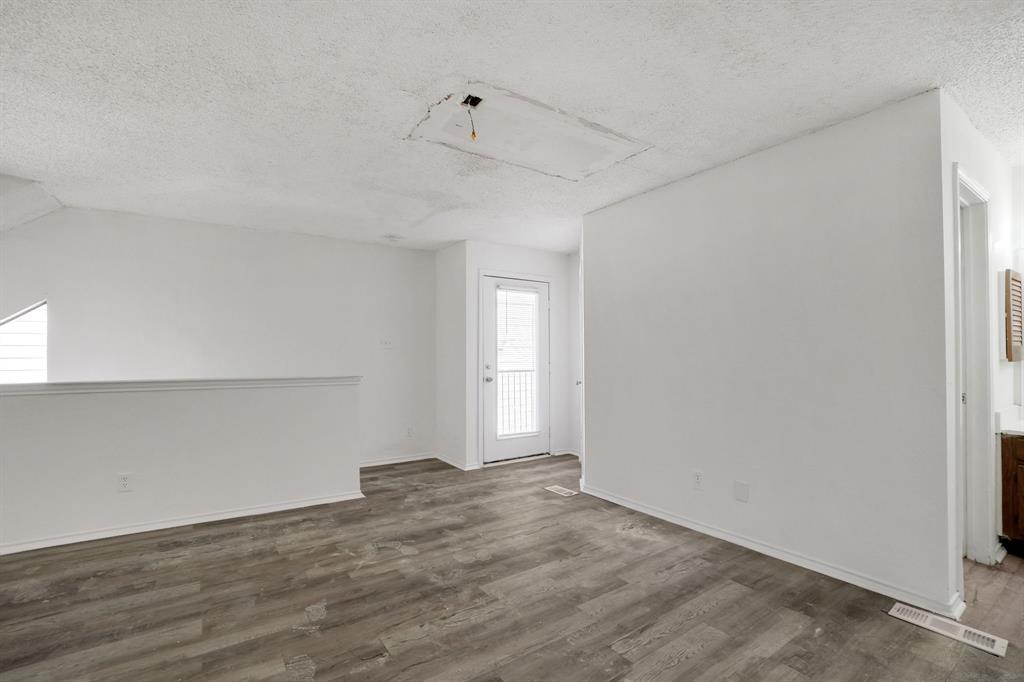 9821 Walnut Street, Unit 204 Dallas, TX 75243 - Photo 27 of 32 a view of empty room with wooden floor and fan