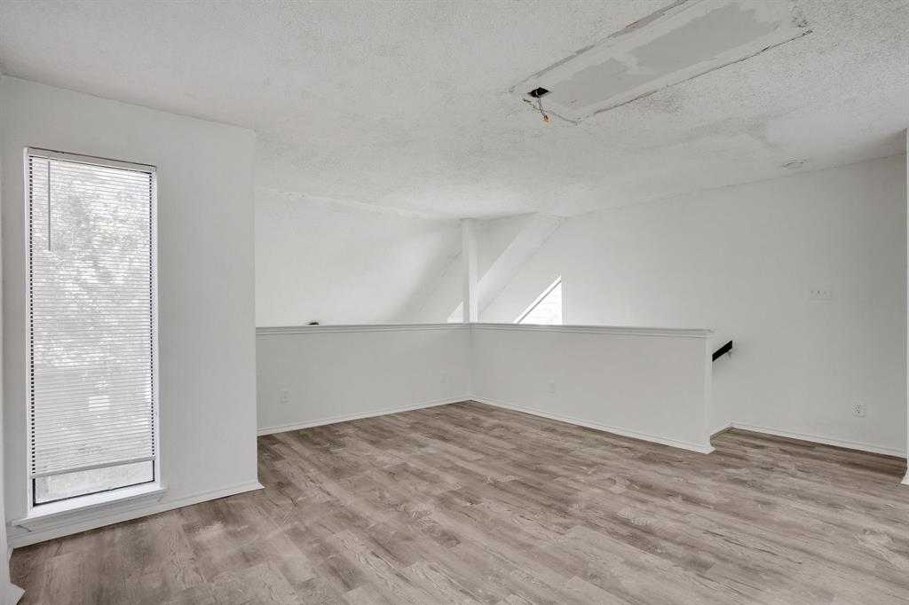 9821 Walnut Street, Unit 204 Dallas, TX 75243 - Photo 28 of 32 an empty room with wooden floor and windows
