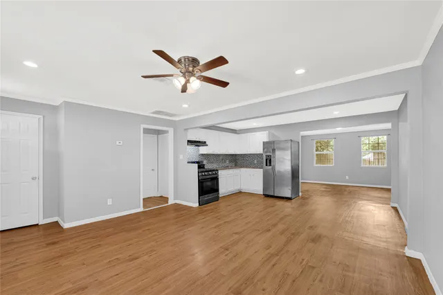 a furnished livingroom with a kitchen