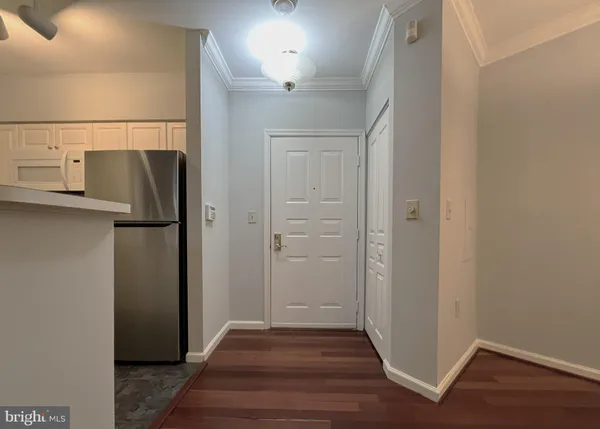 a view of a hallway with wooden floor