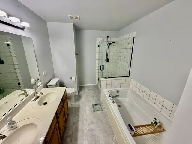 a bathroom with a toilet and a mirror
