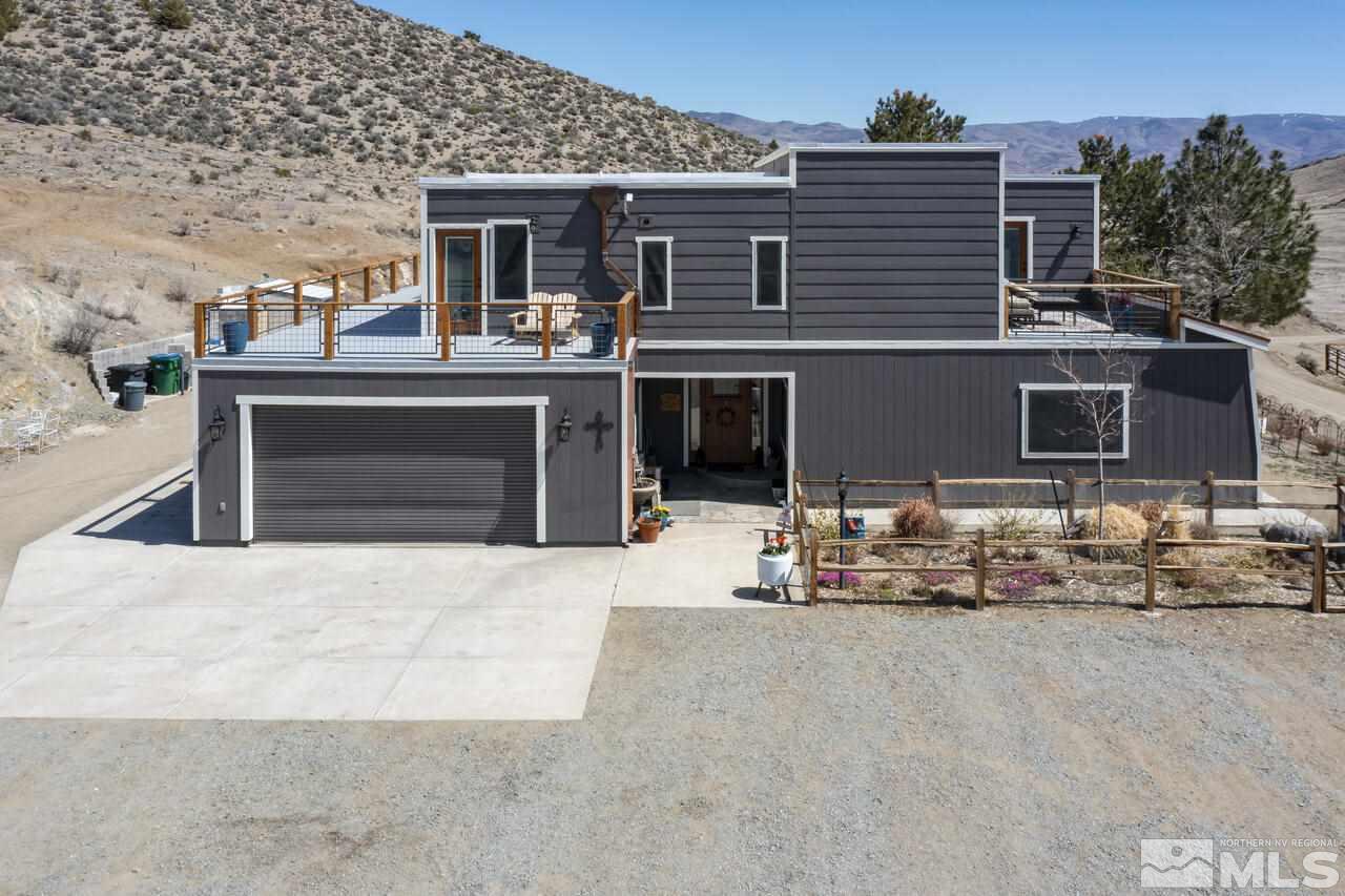 a front view of a house with outdoor seating