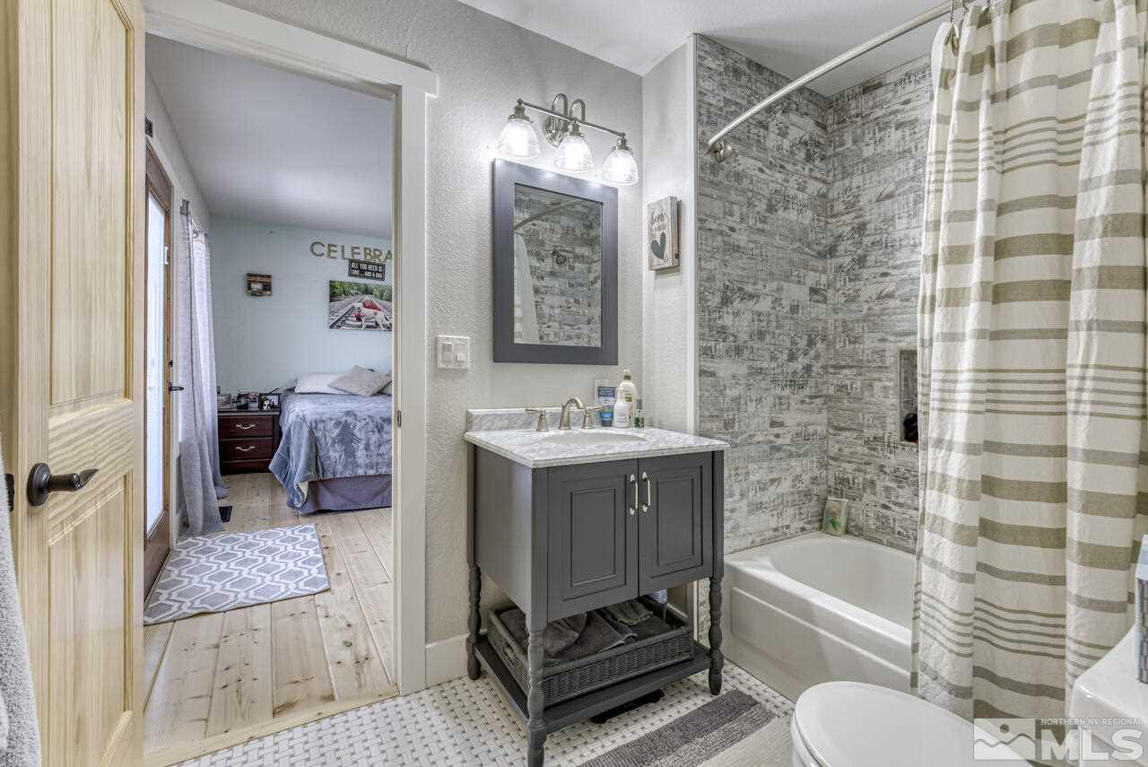 15555 Pyramid Way Reno, NV 89510 - Photo 13 of 39 a bathroom with a tub sink and mirror