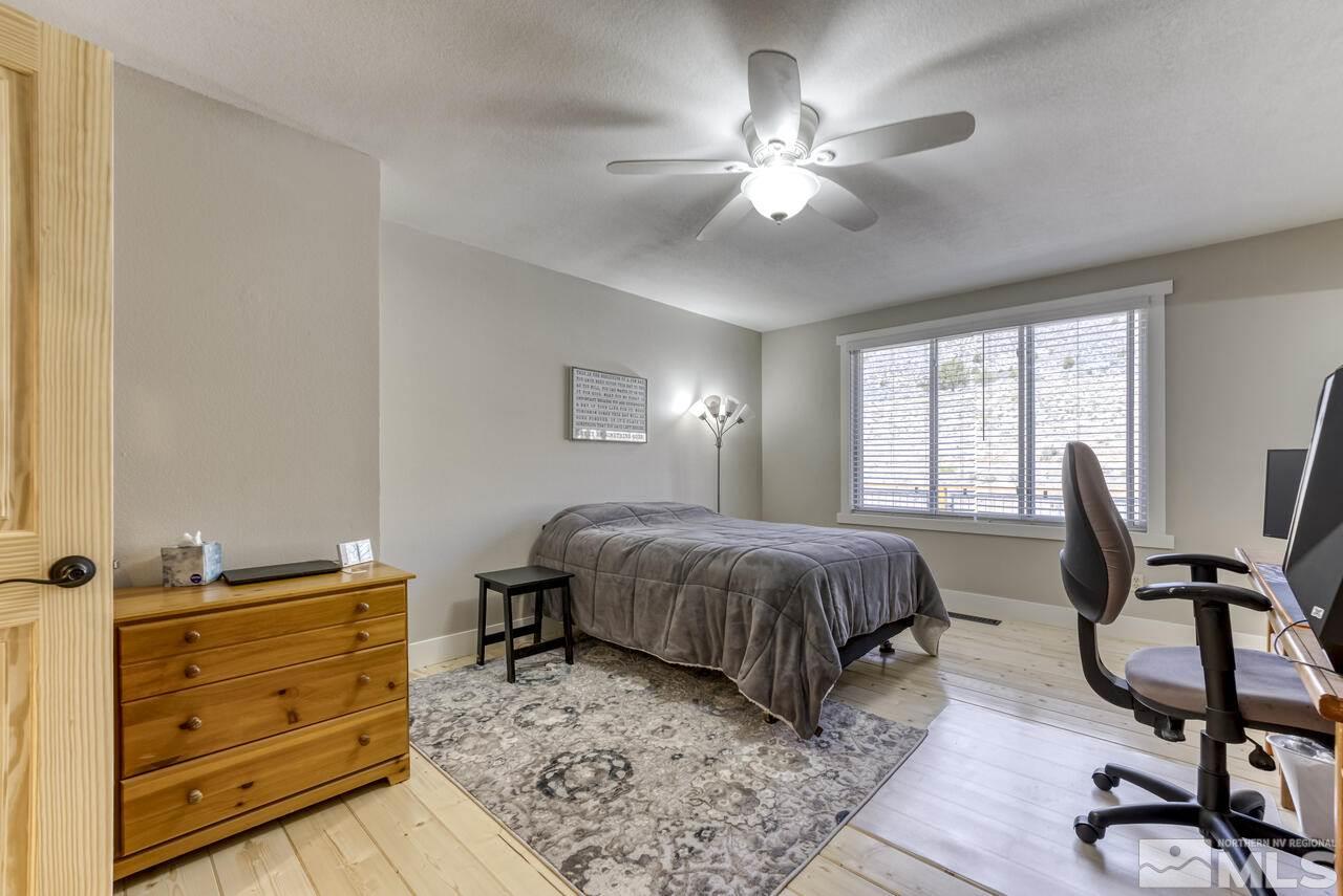 15555 Pyramid Way Reno, NV 89510 - Photo 14 of 39 a bedroom with a bed and a chandelier