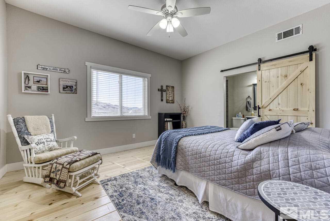 15555 Pyramid Way Reno, NV 89510 - Photo 18 of 39 a bedroom with a bed a couch and dresser