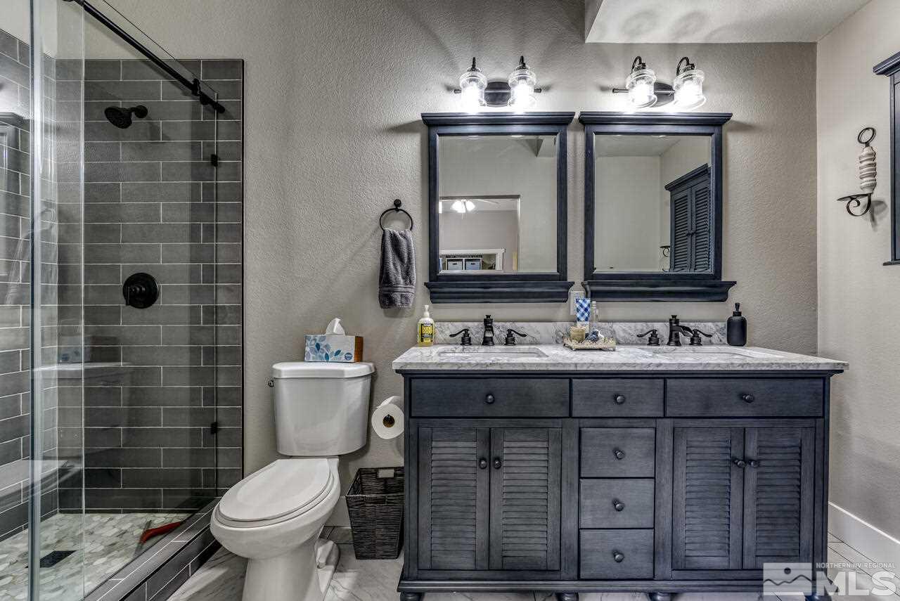 15555 Pyramid Way Reno, NV 89510 - Photo 20 of 39 a bathroom with a toilet sink and mirror