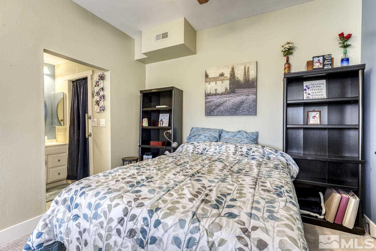 15555 Pyramid Way Reno, NV 89510 - Photo 22 of 39 a bedroom with a bed and a book shelf