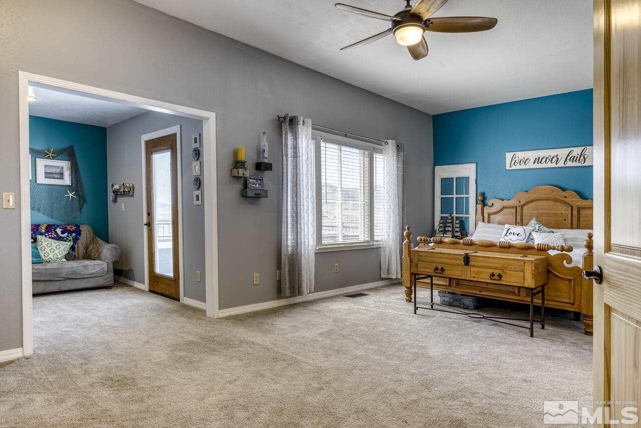 15555 Pyramid Way Reno, NV 89510 - Photo 27 of 39 a bedroom with furniture and a ceiling fan