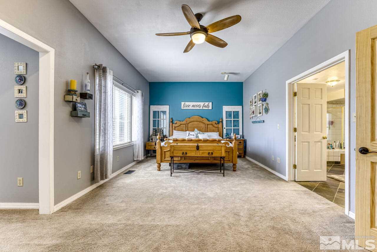15555 Pyramid Way Reno, NV 89510 - Photo 28 of 39 a bedroom with a bed and a large window