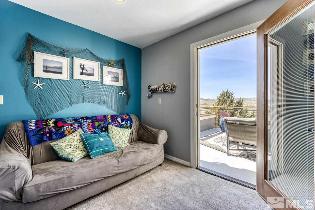 15555 Pyramid Way Reno, NV 89510 - Photo 30 of 39 a living room with a couch and a floor to ceiling window