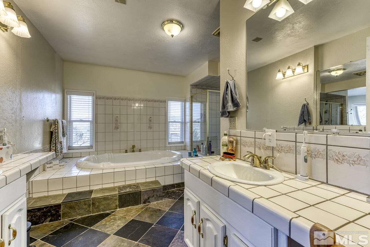 15555 Pyramid Way Reno, NV 89510 - Photo 33 of 39 a bathroom with a double vanity sink and a mirror