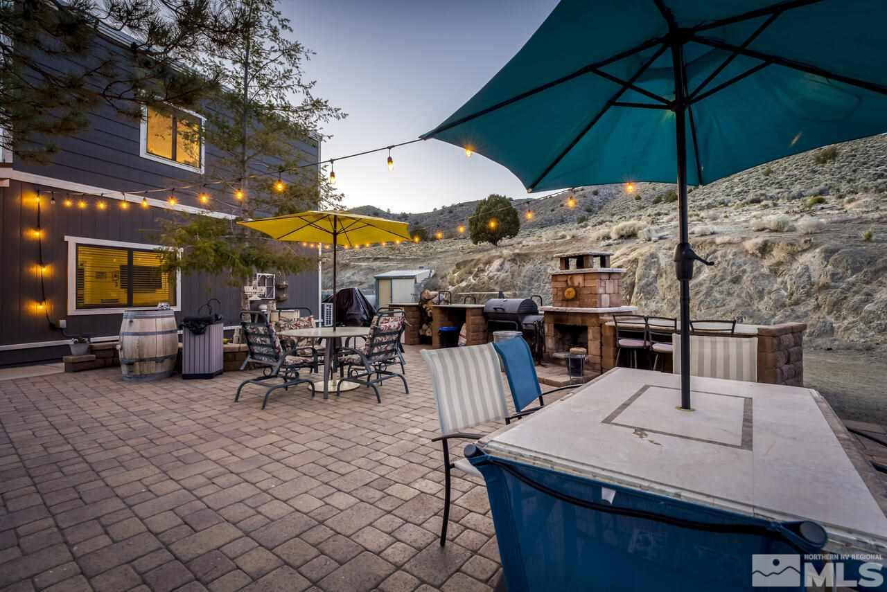 15555 Pyramid Way Reno, NV 89510 - Photo 38 of 39 a view of a patio with a table and chairs under an umbrella