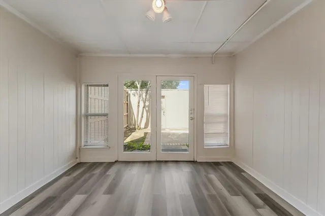 wooden floor in an empty room with a window