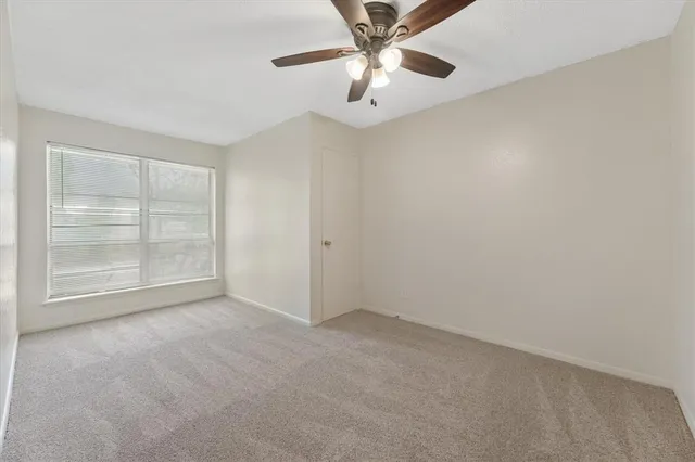 an empty room with a empty space and a ceiling fan
