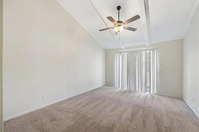 a view of a livingroom with a ceiling fan and window