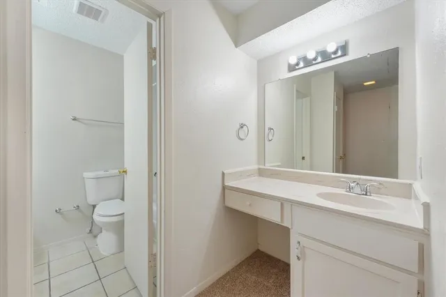 a bathroom with a sink toilet vanity and shower