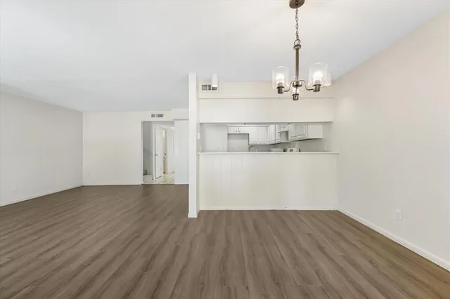 a view of a kitchen with a sink and wooden floor
